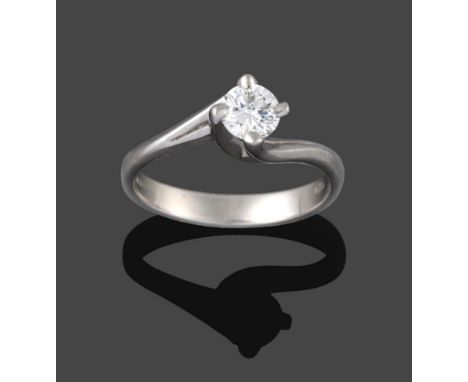 A Platinum Diamond Solitaire Ring, the round brilliant cut diamond in a four claw twisted shoulder setting, on a plain polish