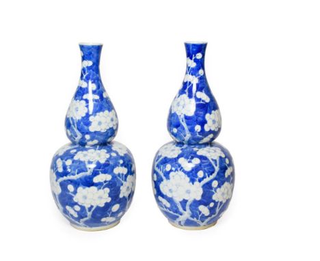 A Pair of Chinese Porcelain Double Gourd Vases, late 19th century, painted in underglaze blue with the Cracked Ice and Prunus