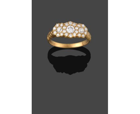 A Diamond Triple Cluster Ring, three graduated old cut diamonds within borders of smaller eight-cut diamonds in yellow claw s