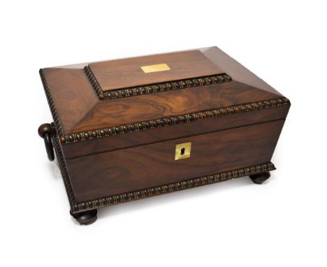 A Regency Rosewood Work Box, circa 1820, of rectangular form with ring handles and gadrooned angles, the caddy top with vacan