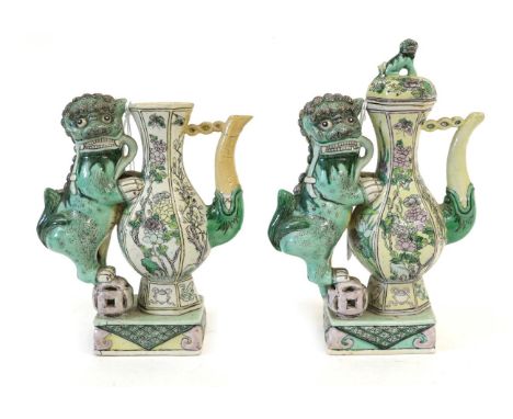A Pair of Chinese Bisque Ewers and A Cover, in Kangxi style, of baluster form with dog of fo handles on rectangular bases, pa