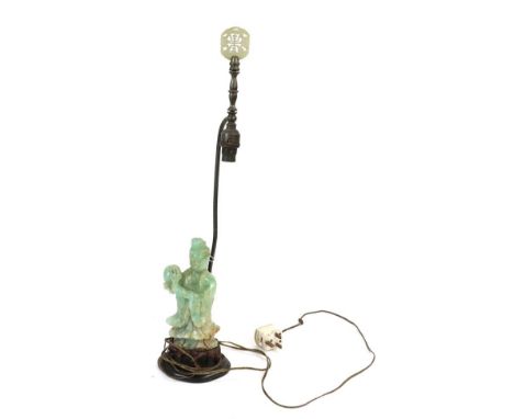 A Chinese Jade Type Figure of Guanyin, late 19th/20th century, standing holding a flower, 22cm high, mounted as a lamp base
