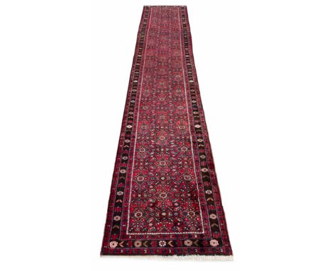 Persian runner, with floral pattern on a red ground, 162" x 33" 