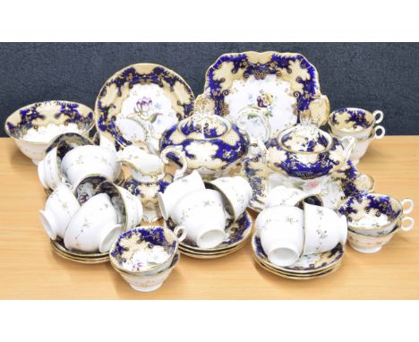 English 19th century porcelain tea service, decorated gilt highlight scroll and decoration on a enamel blue round, each piece