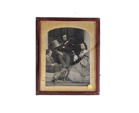 An Ambrotype Family Portrait Group,  quarter-plate,  father seated in doorway, with daughter, son and terrier in front of him