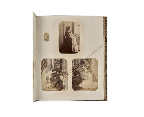 A Quarto Family Album of Photographs,  crimson morocco, gilt scroll and foliate decoration, containing amateur family images 