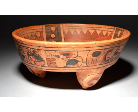 A Mayan tripod bowl Mexico the interior painted with geometric designs, the exterior with a band of stylised decoration inclu