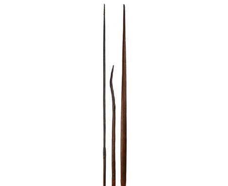 A Solomon Islands bow Melanesia one end with bound fibre and the flat side stained black, 193cm long, with a long arrow and a