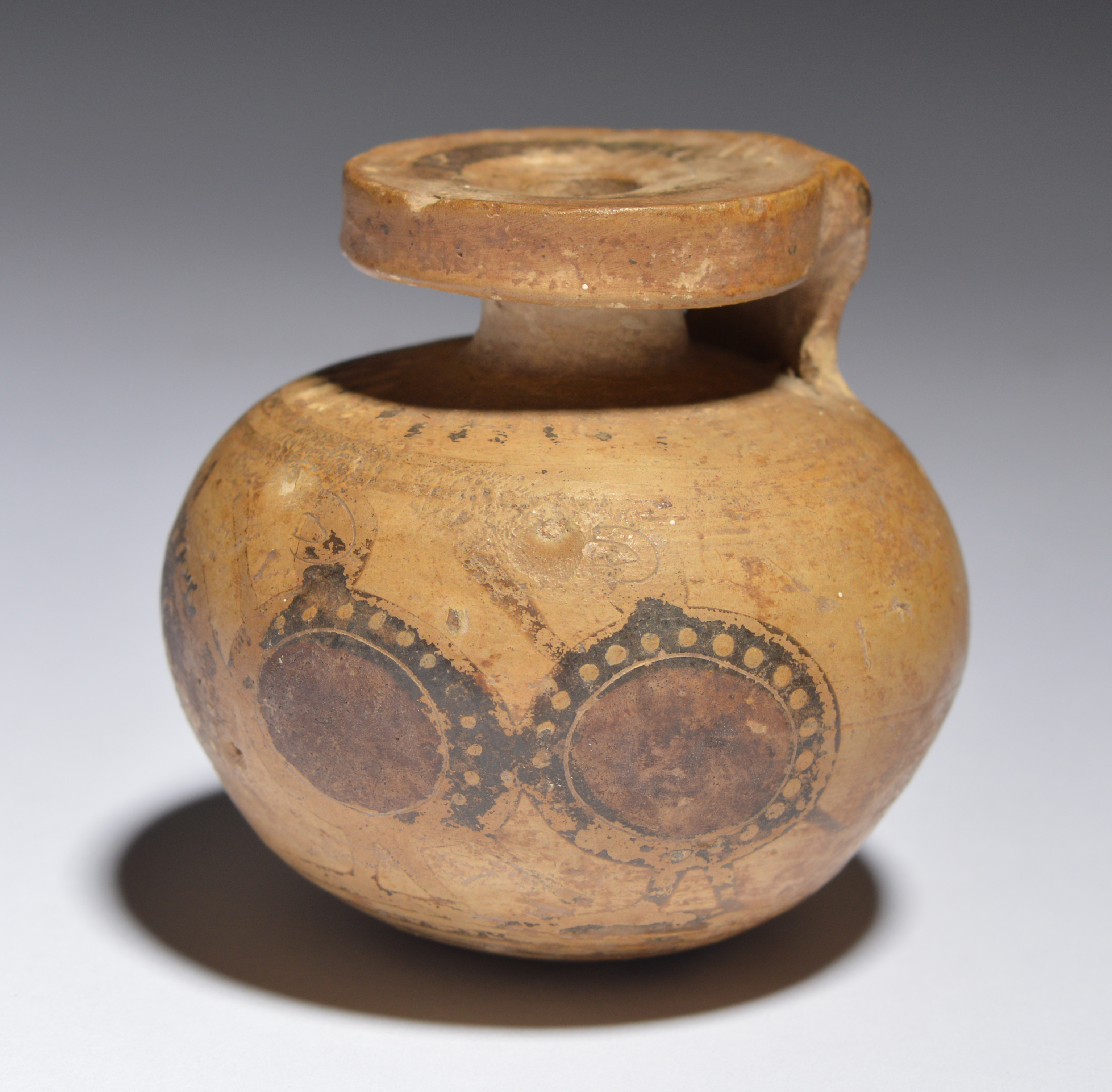 A Greek pottery aryballos circa 6th century BC with a wide rim and ...