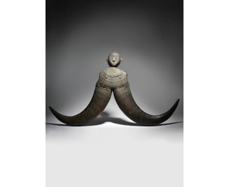 A Yami magamaog Taiwan carved wood and buffalo horn, the head with an attachment loop to the top and with pierced ears, the c