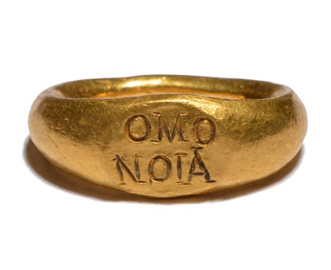A Roman gold ring circa 2nd century AD inscribed with the Greek word OMONOIA, concord/harmony, over two lines, 2.2cm wide, 13