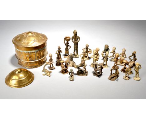 An Ashanti&nbsp;forowaGhana brass with embossed decoration, 11cm high, twenty two Ashanti brass gold weight figures, a mud fi
