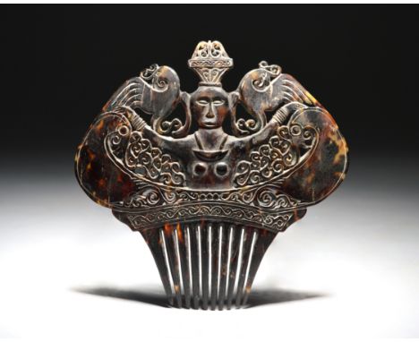 λ A Sumba comb Indonesia tortoiseshell, carved and pierced with a female figure, birds and scrolls, 13.5cm wide.