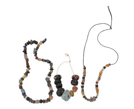 An Egyptian bead necklace with an Udjet Eye amulet and a two strung glass bead necklaces, Roman and Saxon. (3)