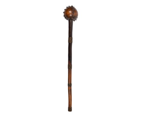 A Zulu knobkerrie South Africa with an ovoid head having applied metal studs and wirework bands to the shaft, 62.5cm long.