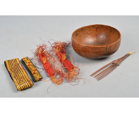 Four Solomon Islands armbands Melanesia orchid fibre, including a pair with red dye, a Solomon Islands comb with remains of f