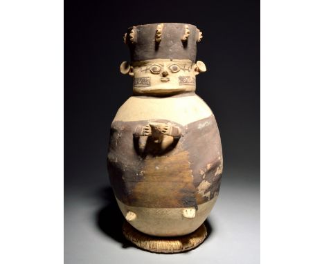 A Chancay figural vessel Peru, circa 1100 - 1400 AD ceramic with brown slip, modelled with a headdress and spool earring and 