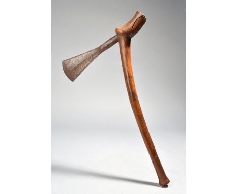 A Chokwe axe Angola with a heavy iron blade with incised decoration, with a shaped wooden shaft, 44cm high. Provenance Collec