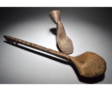 A Kulango pounder spoon Ivory Coast wood, 29.5cm long, and an Akan long handled ladle, 62.5cm long. (2)