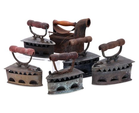 A GROUP OF VINTAGE LAUNDRY CHARCOAL IRONS
Comprising five charcoal irons with wood handles and one charcoal iron example with