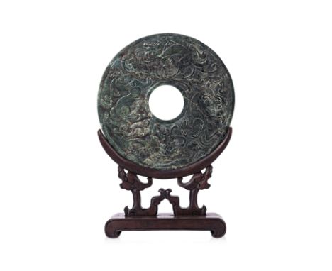 A LARGE CHINESE JADE BI DISC
The front decorated with three relief carved chilong and a dragon, stylised scrolling birds to t