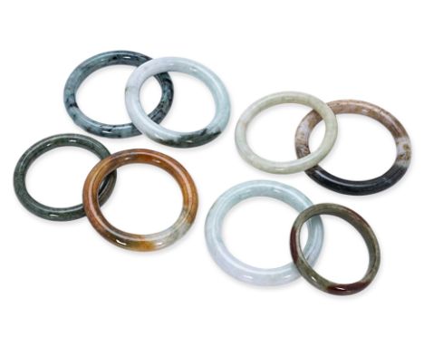 A GROUP OF EIGHT JADE BANGLES
Various tones of jade
54mm to 64mm inner diameter
Condition: For a condition report or further 