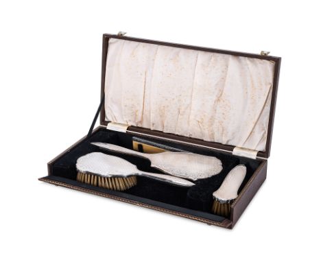 AN ENGLISH SILVER DRESSING TABLE SET
Broadway & Co, Birmingham 1950/51; comprising a mirror, and two brushes, with engine tur