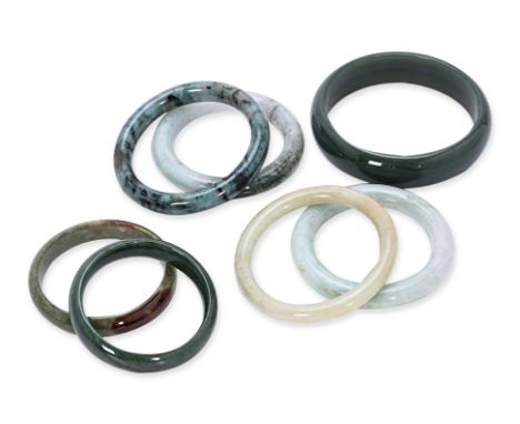 A GROUP OF SEVEN JADE BANGLES
Various tones of jade
54mm to 80mm inner diameter
Condition: For a condition report or further 