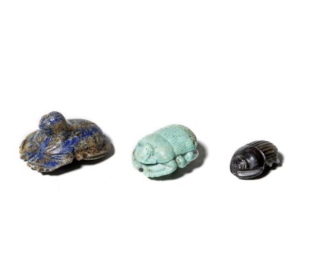  Three Egyptian scarabs Late Period-Ptolemaic Period, circa 664-30 B.C.Comprising a lapis lazuli falcon-headed scarab, the un