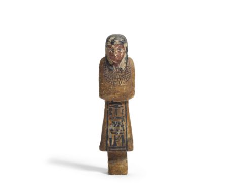  An Egyptian polychrome wood overseer shabti New Kingdom, circa 1500-1069 B.C.Wearing a tripartite wig, broad collar and char