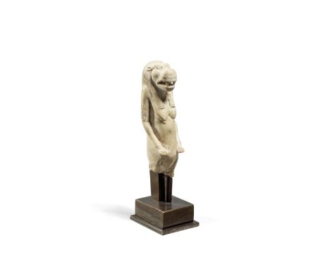 An Egyptian indurated limestone figure of Taweret Late Period, circa 664-332 B.C.The hippopotamus-headed goddess wearing a f