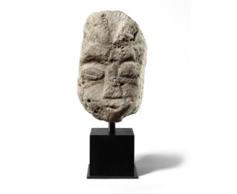  A Celtic limestone head of a deity, probably Cernunnos Circa 1st Century B.C.-3rd Century A.D.Surmounted by a pair of stylis