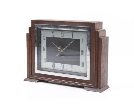 An Art Deco Smiths Sectric oak cased electric mantel clock. In a stepped rectangular case, chrome chapter, Roman numerals and