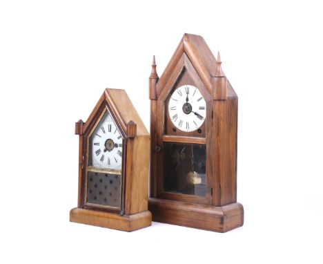 Two 20th century gothic style pendulum mantel clocks. Comprising a Teutonia clock manufactory clock with an oak case, the met