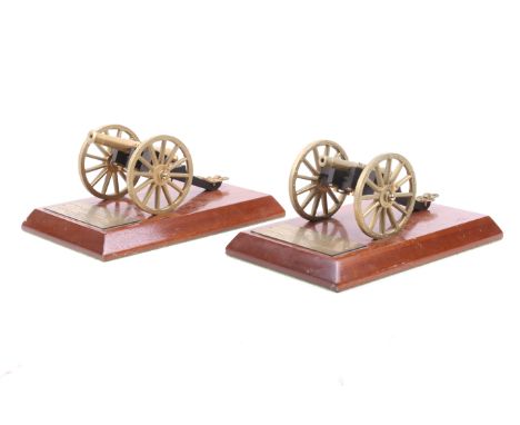 Two vintage brass 'Waterloo Cannons'. Both mounted on wooden stands and bearing plaques stating they were presented to Mr Tre