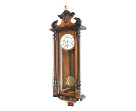 A late 19th century Vienna regulator style wall clock. Weight-driven movement, white enamel dial with black Roman numerals, s