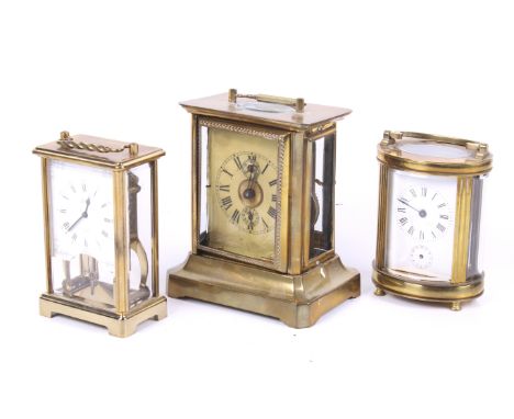 Three vintage brass carriage clocks. Comprising a Schatz 8 day clock, the white dial with Roman numerals, H13.5cm (excluding 