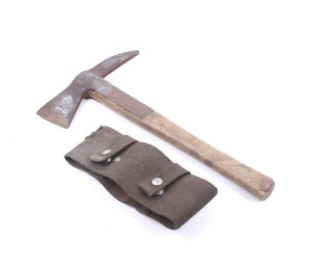 A Brades 313 fire fighter's axe and canvas cover. Having a wooden handle with the broad arrow mark, 39cm long