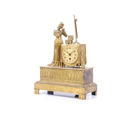 A 19th century brass ormolo figurine mantel clock by Pons. Having a figure of a lady at her dressing table, raised on a 'Goth