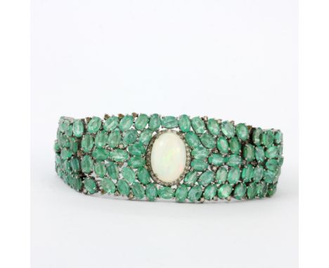 A white metal (tested silver) and emerald bracelet set with diamonds and a large oval cabochon opal with 9ct tested gold clip
