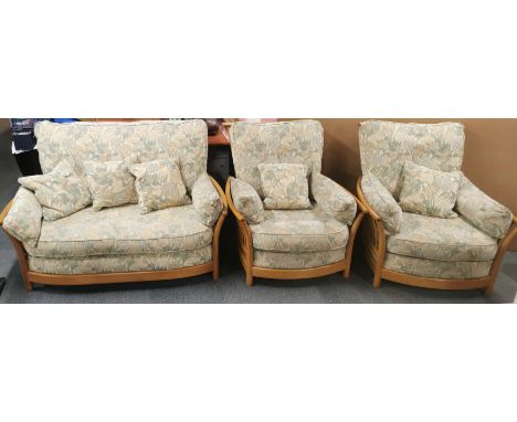 An Ercol three piece cottage suite comprising of sofa/settee and a pair of armchairs, sofa size. 145 x 96cm.