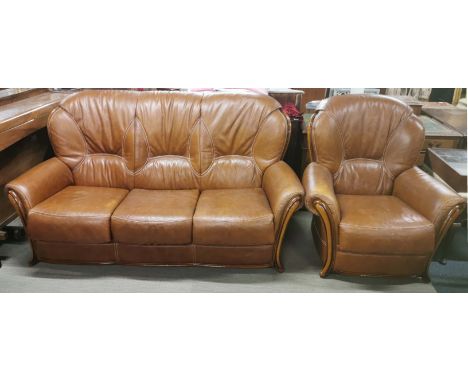A brown leather three seater sofa, together with a matching armchair, sofa L. 180cm H. 105cm.