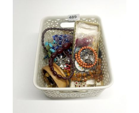 A vintage faux cherry amber necklace and other items.