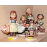 Five Hummel figures of children, tallest 7 1/2" high, in various poses (damages)