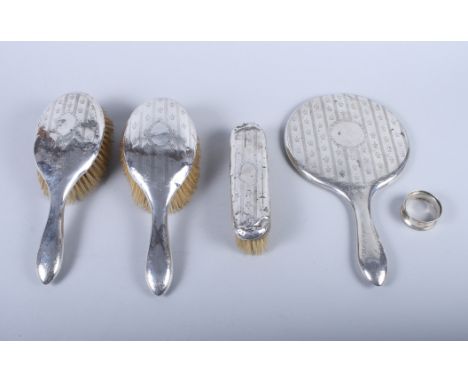 A silver mounted four-piece dressing table set, a silver napkin ring and a number of silver handled dessert knives, various