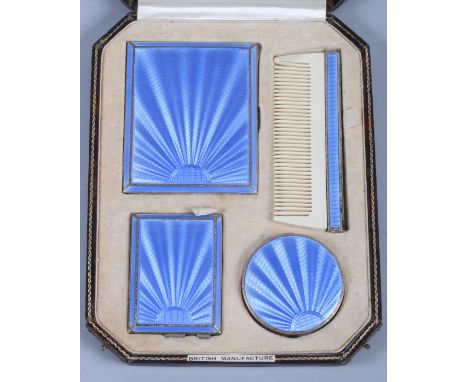 A George V silver four-piece and blue guilloche enamel vanity set, comprising a compact, a comb, a match holder and a cigaret