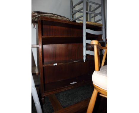 A mahogany three-shelf open bookcase, on four supports