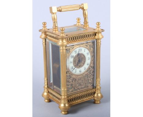 An early 20th century gilt cased carriage clock with painted dial and Arabic numerals, floral decoration, 5 1/2" high (damage
