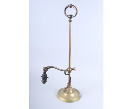 A brass adjustable table lamp, on circular base