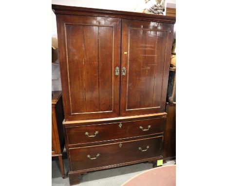 An early 19th century mahogany linen press enclosed two doors over two long drawers, on bracket feet, 45" wide